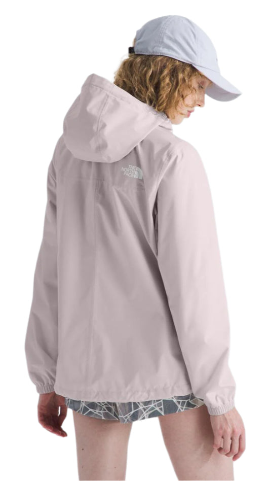 A person wearing a light purple hooded jacket and a light blue baseball cap, standing at an angle with their back to the viewer.