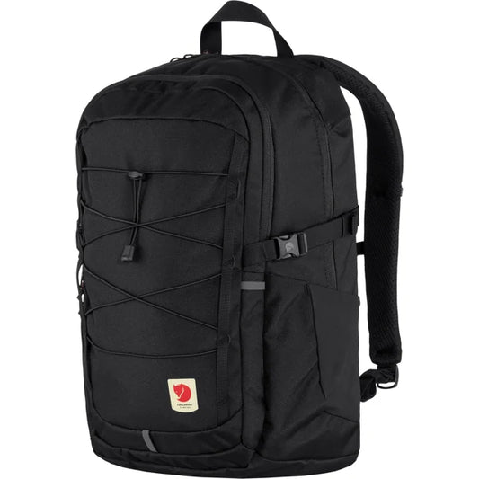 Black backpack with front straps and a small logo at the bottom.