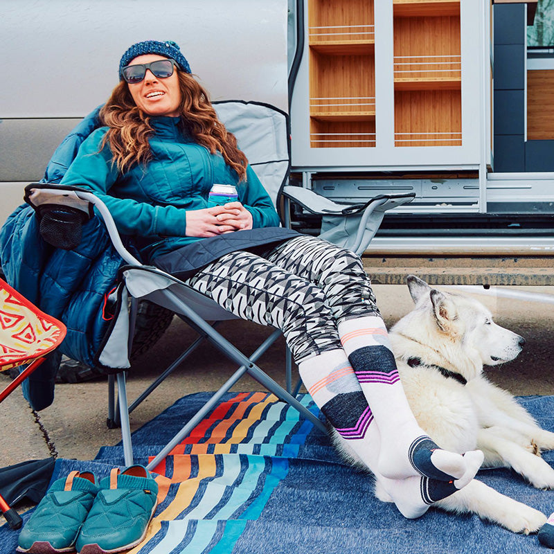 Woman sitting in camping chair with colourful socks