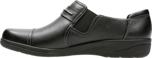 A black slip-on shoe with a low heel and a textured upper.