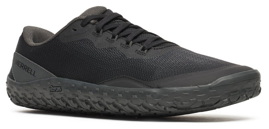 A black shoe with black laces and a textured sole.