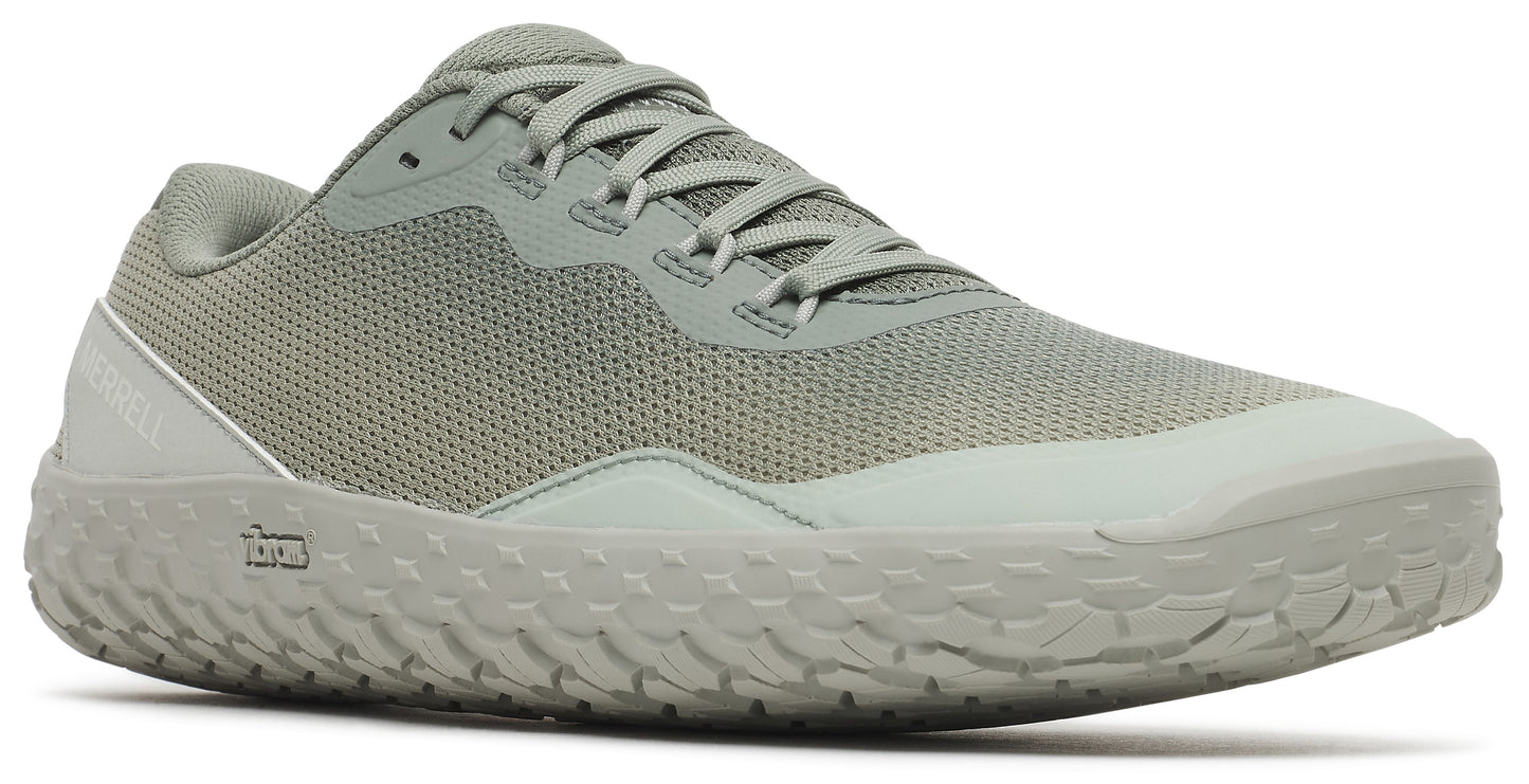 Low-top athletic shoe with a green mesh upper and a textured, light-colored sole.