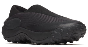 Black slip-on shoe with a thick treaded sole.