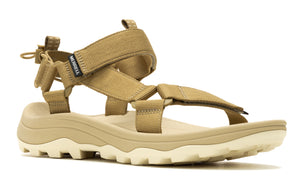 Tan-colored sandal with straps, supportive midsole, and lugged outsole.