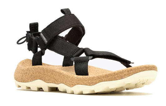 A black sandal with tan cork footbed and a light-colored ridged sole.