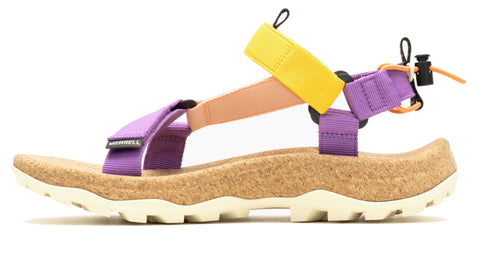 Side view of a sandal featuring a tan cork footbed, a thick white ridged sole, purple, tan, and yellow straps, and a black toggle.