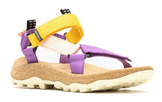 Sandals featuring purple straps, a yellow ankle strap, and a cork sole with a white, ridged bottom.