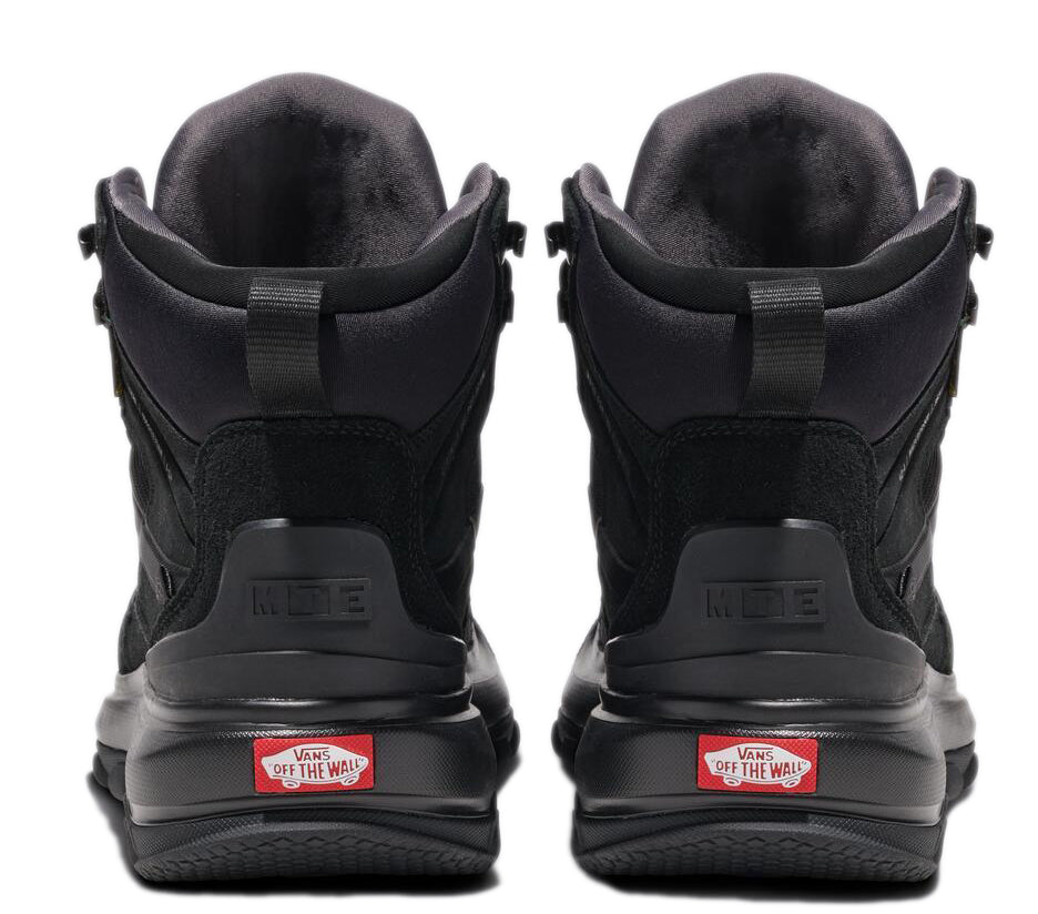 Back view of a pair of black mid-top shoes with 'VANS off the wall' logo visible at the heel.