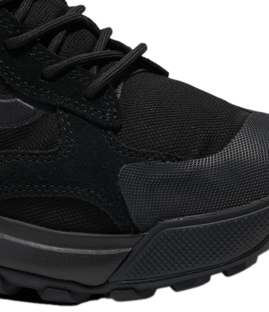 Close-up of a black sneaker featuring laces, suede-like accents, and a textured, protective toe cap.