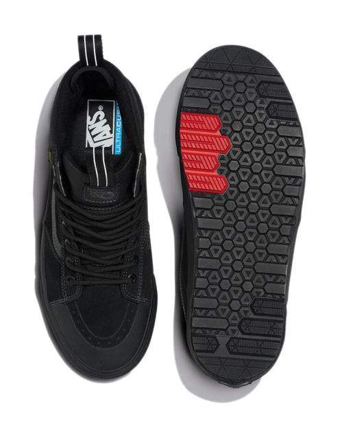 Black mid-top shoes with laces, ULTRA CUSH label visible on the inside, and thick rugged black and red soles.