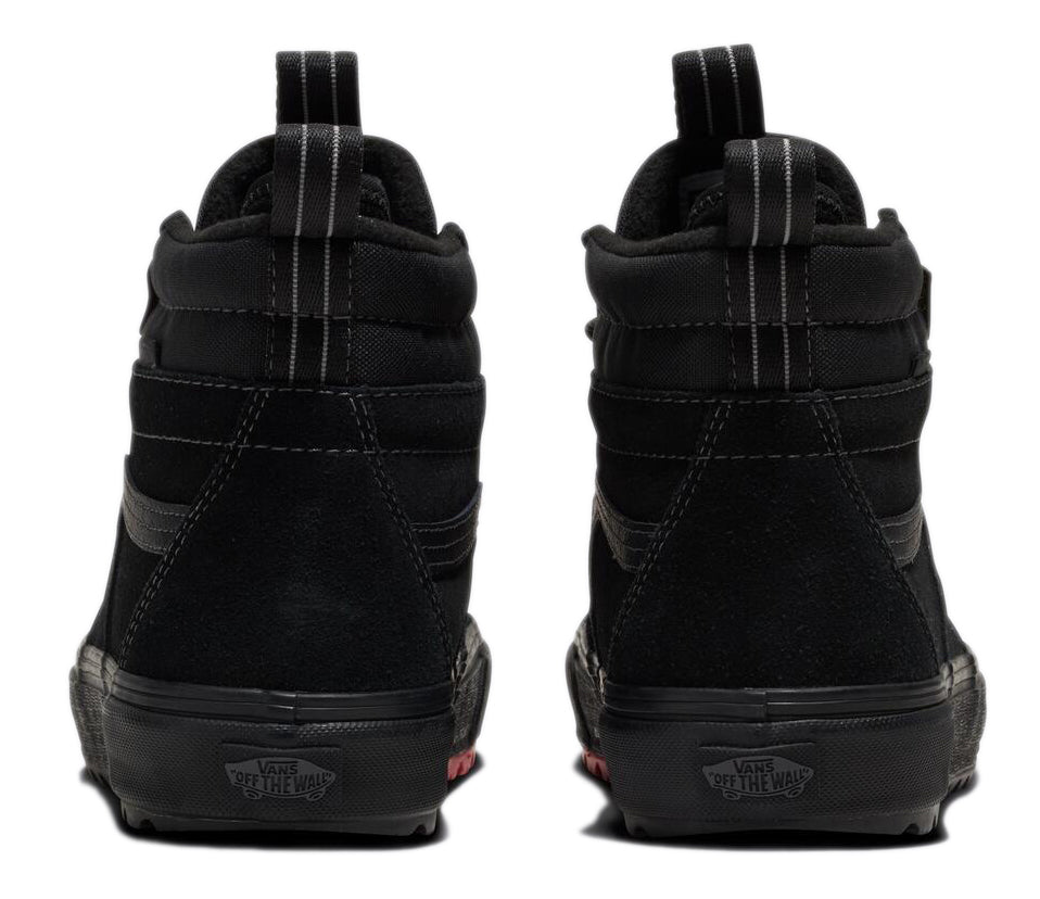 Two black high-top sneakers showing their backs, with black soles and a suede-like upper, each featuring a vertical fabric stripe and a loop at the top of the heel.