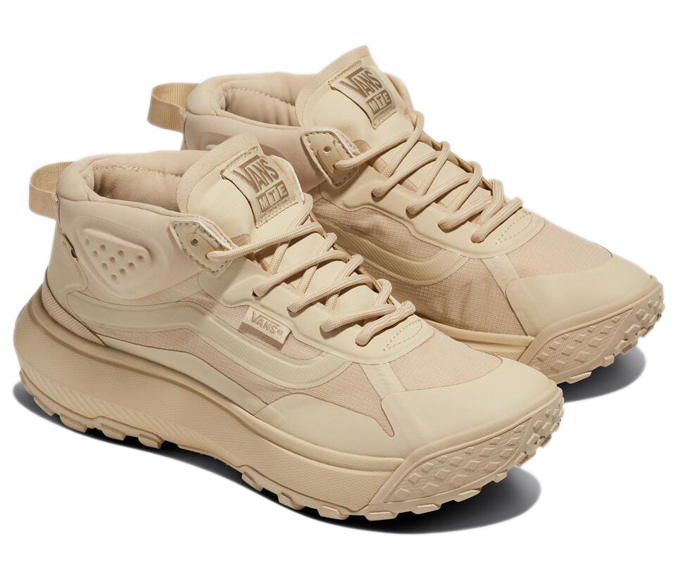 Tan-colored, mid-rise sneakers with laces, rubber soles, and visible 'VANS MTE' text.
