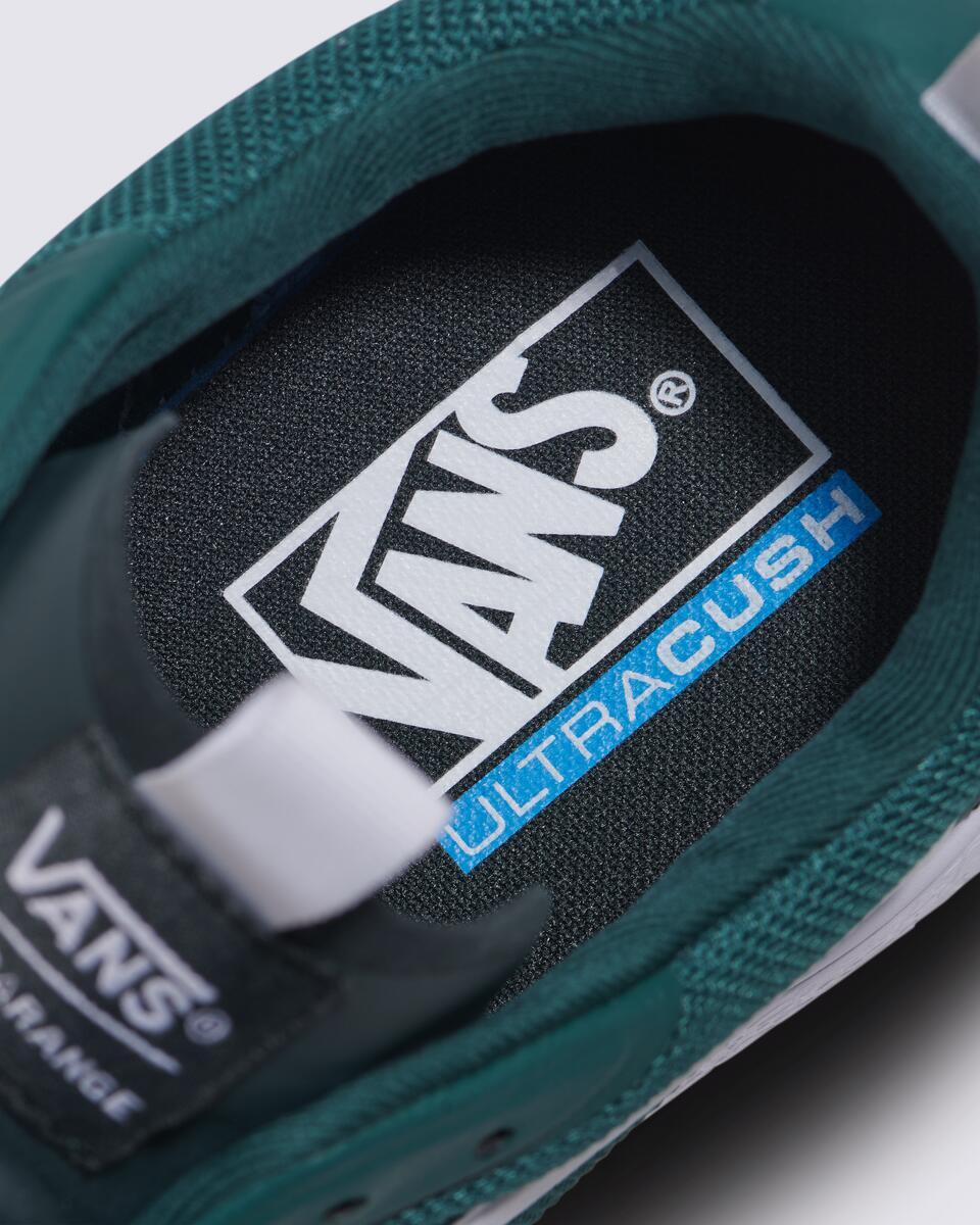 Inside view of a dark green shoe, showing the insole with "VANS ULTRACUSH" written in white and blue within a black rectangle.