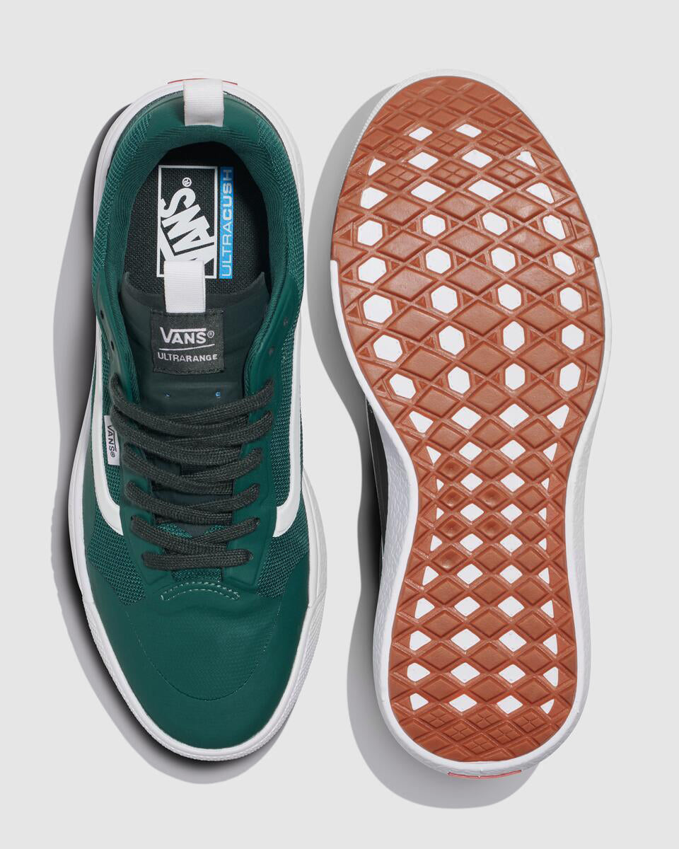 Two green sneakers, one showing the insole, white stripe, and the text "VANS Ultracush", the other showing the brown sole with white lattice pattern.