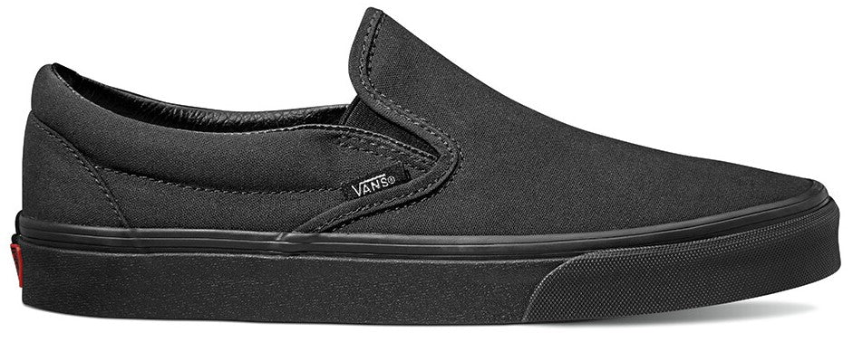 A black slip-on shoe with a black sole, featuring a Vans tag on the side.