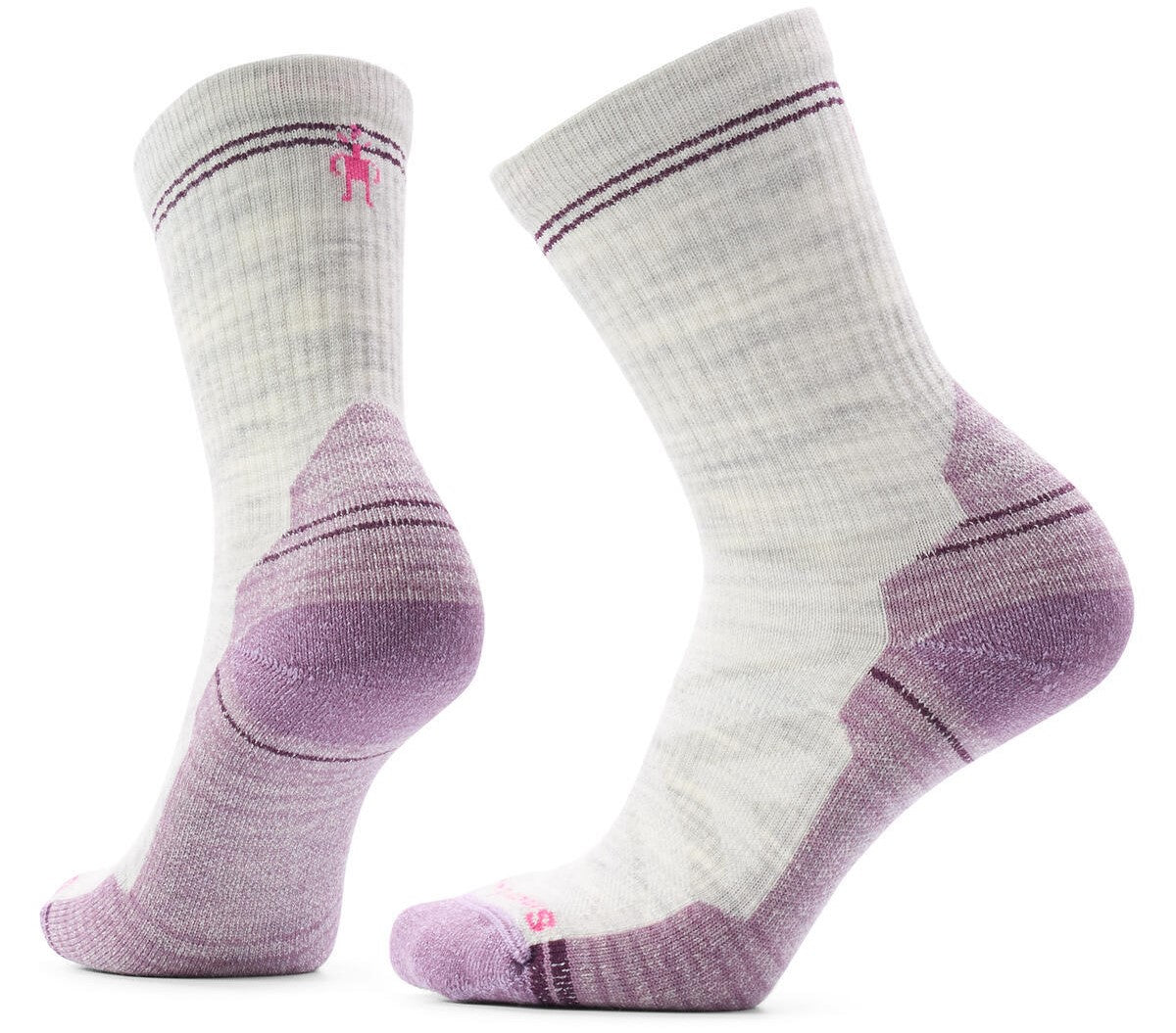 A pair of light heather grey crew-length hiking socks with lavender-colored heels, toes, and arch support panels. The socks feature a subtle textured knit pattern and a small pink logo embroidered near the top cuff.