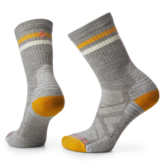 Two gray crew socks with gold and white stripes on the upper calf and gold on the heel and toe.