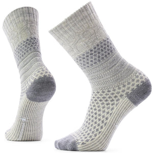 A pair of textured grey and white crew socks, featuring a honeycomb knit pattern on the foot and lower leg, with ribbed cuffs and solid grey toe and heel reinforcement.