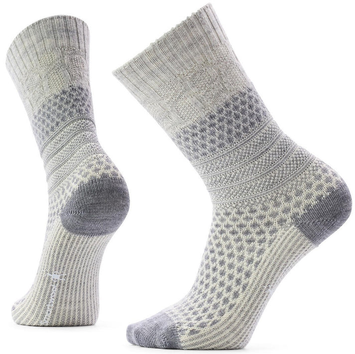 A pair of textured grey and white crew socks, featuring a honeycomb knit pattern on the foot and lower leg, with ribbed cuffs and solid grey toe and heel reinforcement.