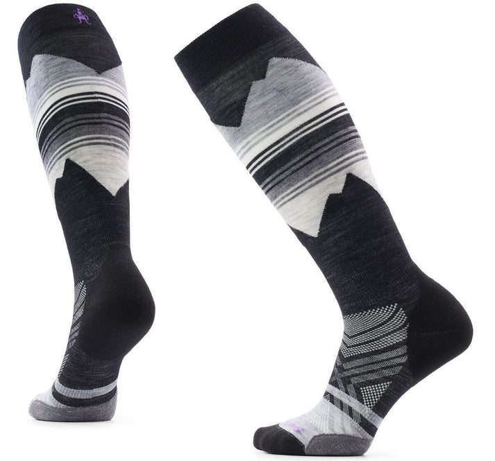A pair of knee-high performance socks featuring a black and gray color scheme with a graphic mountain range design in white and gray, and striped patterns near the top cuff, showcased from both a side and rear perspective.