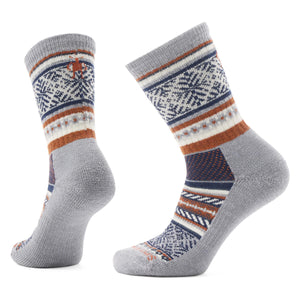 Two gray crew socks with geometric designs in blue, brown and white.