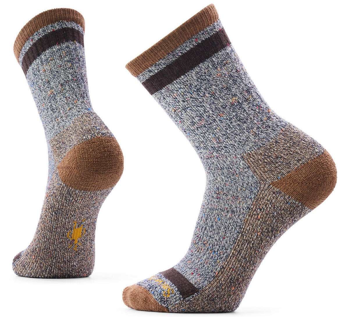 A pair of grey, brown, and speckled wool hiking socks. The cuff has brown and dark stripes. There is brown reinforcement on the toe and heel, and a small yellow icon embroidered on the side.