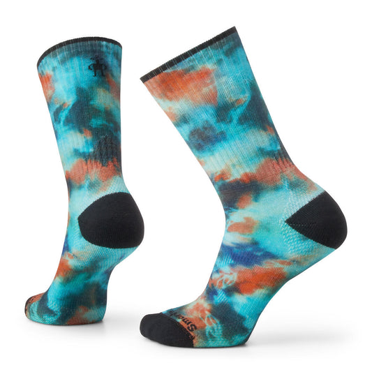 Two socks in a tie dye pattern with teal, orange, and black.