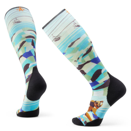 Two knee-high socks with a mountain and bear design, a light blue, green, purple, and brown color palette, and black heel and toe.