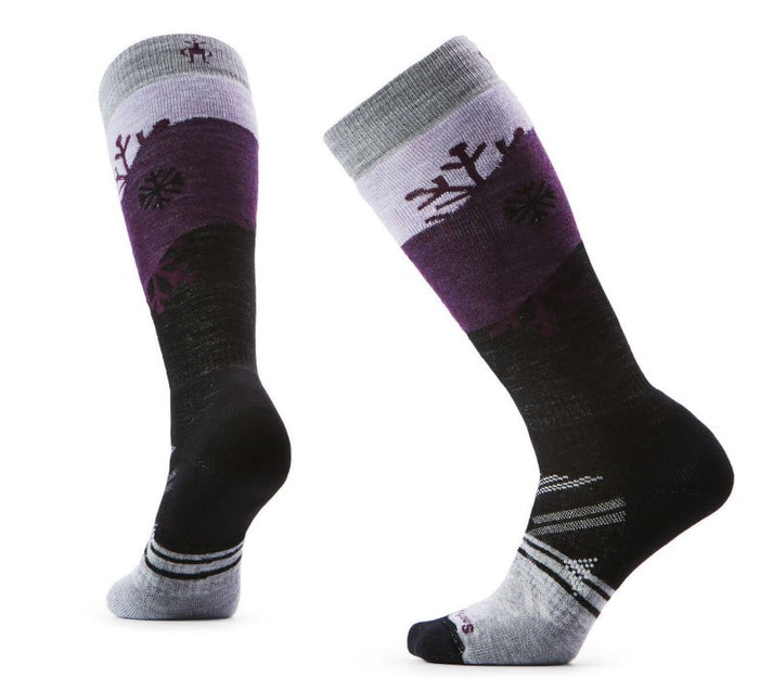 Two ski socks, each with a gray cuff, a lavender band with snowflakes, a dark purple stripe, and a black lower portion with gray reinforcements.