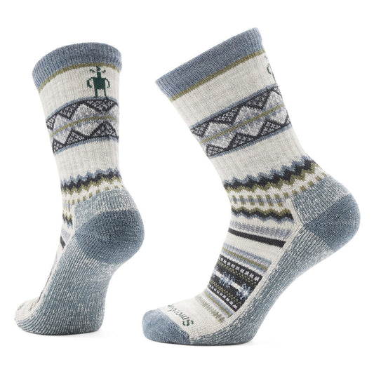 Pair of patterned crew socks with a grey toe and heel and a stick figure design on the ankle.