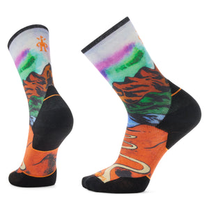 Pair of crew socks with landscape and Aurora Borealis design; black heel, toe, and band.