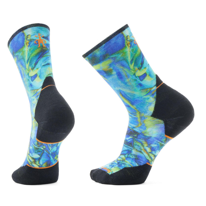 Two crew socks with blue, green, and black patterns and black heels and toes.