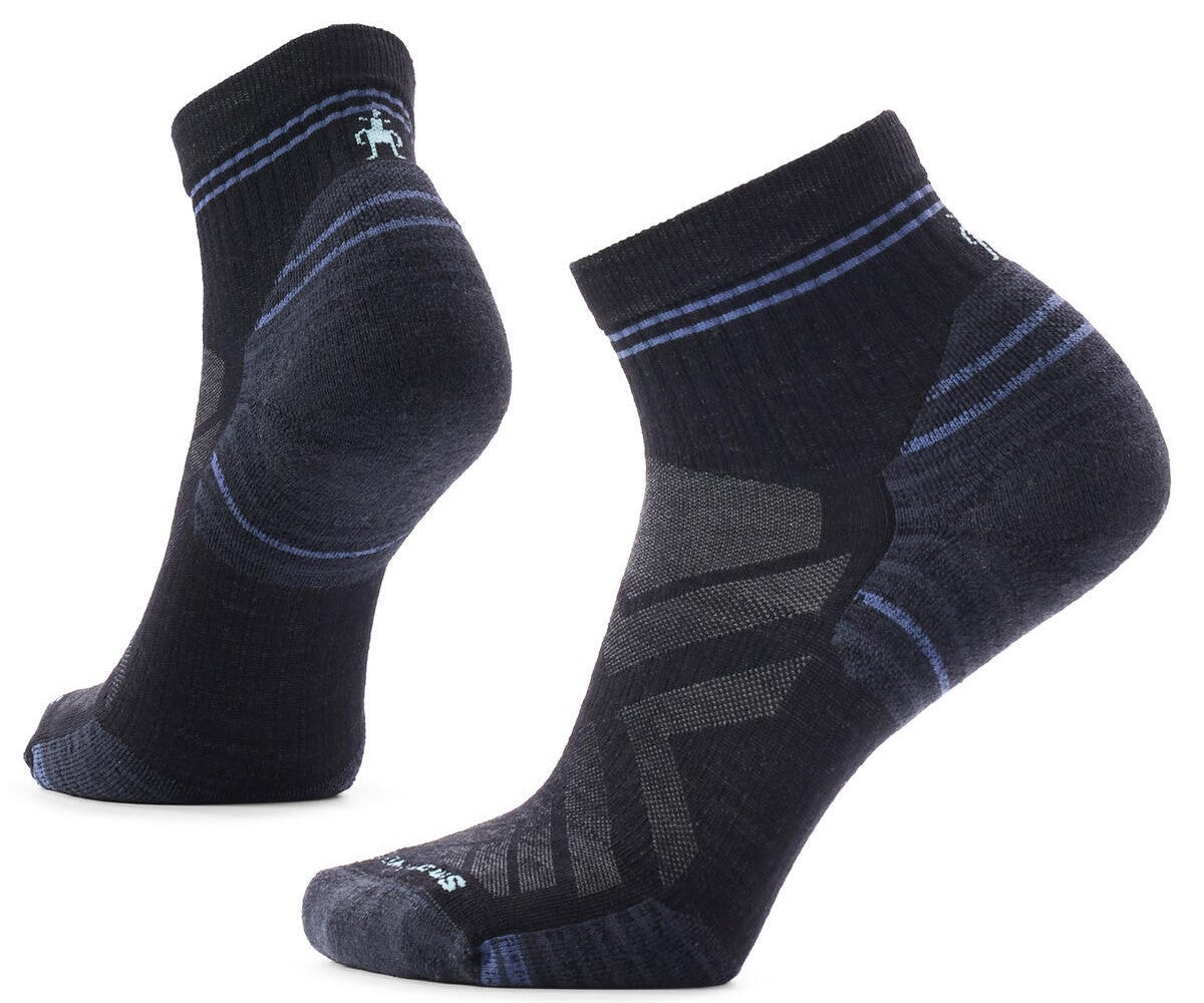 A pair of black and charcoal gray performance ankle socks with subtle blue horizontal stripes on the ankle cuff and heel, featuring an athletic fit and reinforced zones.