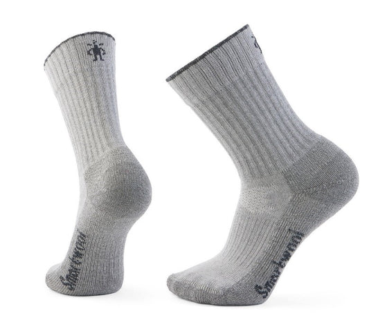 Two gray wool crew socks with ribbed texture and dark gray trim, one showing the side and the other the back. The word "Smartwool" is written on the top of the foot.