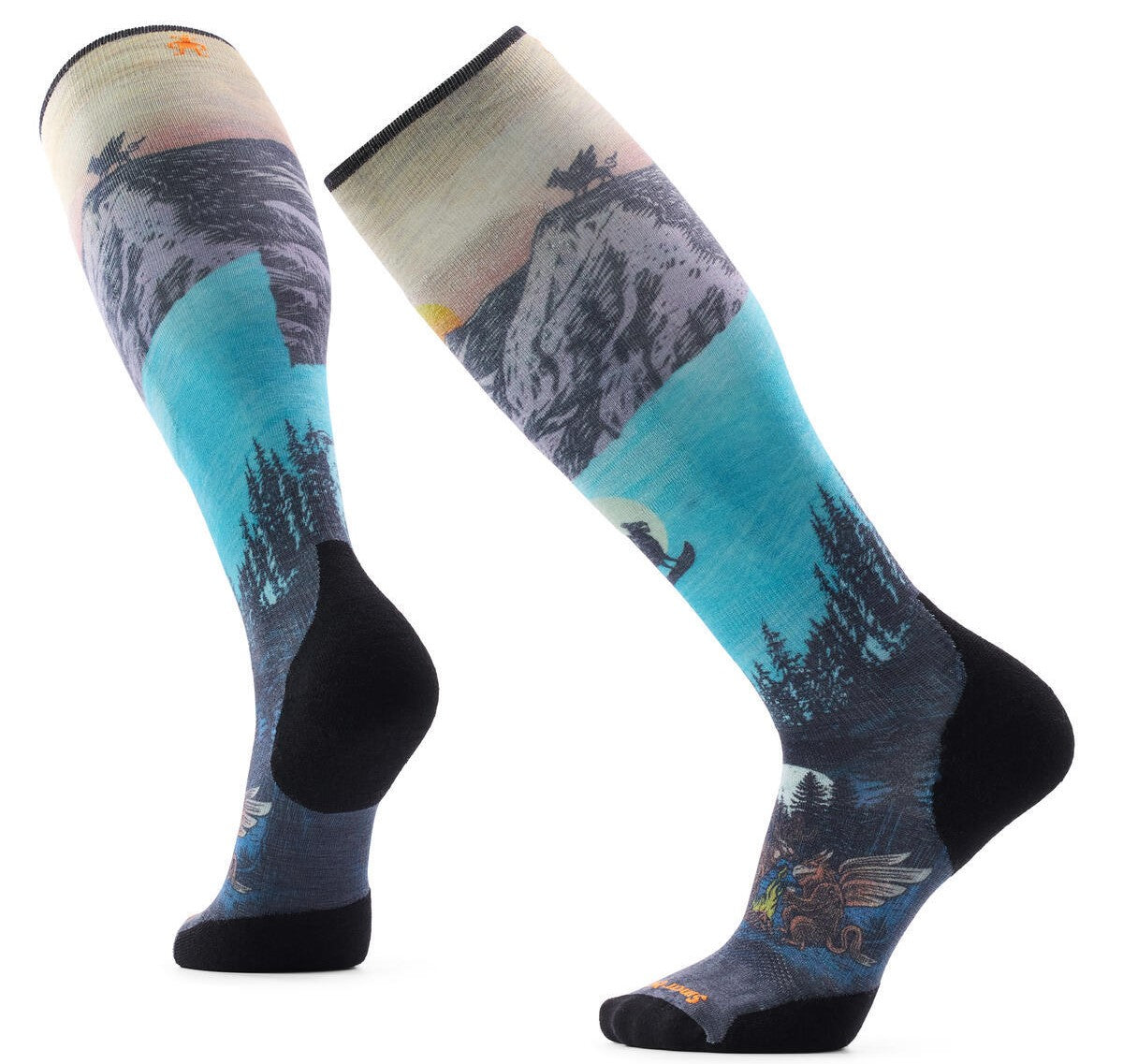 A pair of knee-high socks featuring an illustrated mountain landscape scene with a sunset sky, a silhouetted figure on a cliff, a forest, and a mythological griffin creature near the toes, set against a plain white background.