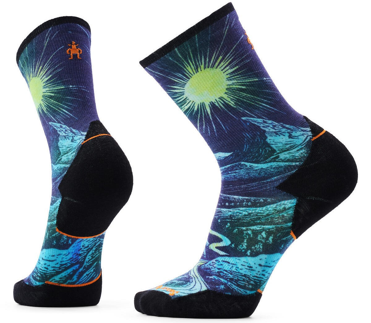 A pair of crew-length socks featuring a vibrant night landscape graphic with a bright, stylized sun, rolling blue hills, and a winding path, contrasted by solid black toes and heels with small orange accents and an orange circular logo near the top cuff.