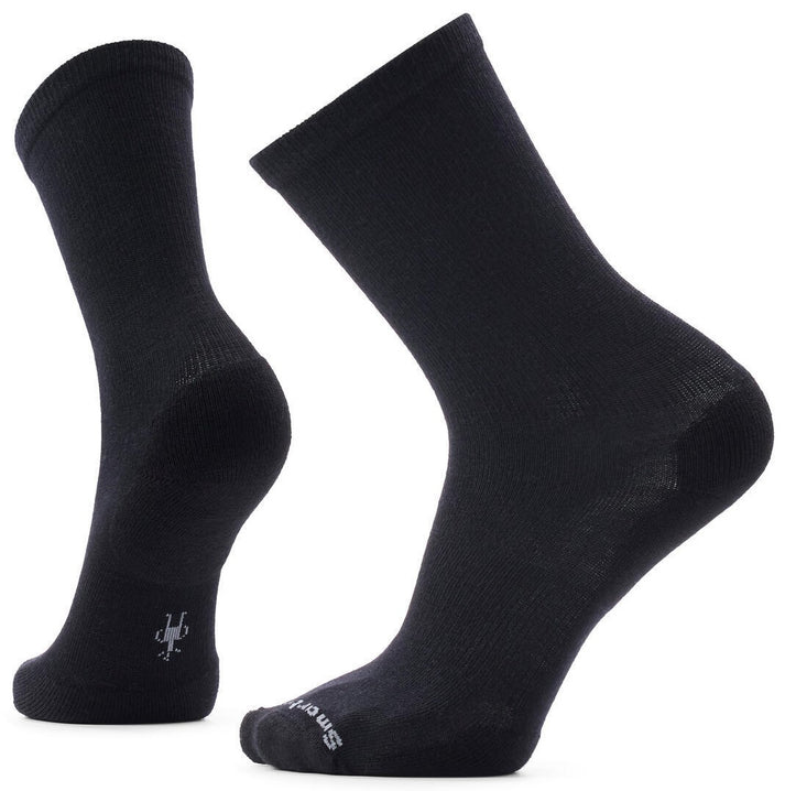 A pair of black mid-calf socks shown from two different angles, featuring a small grey Smartwool logo on the ankle and toe.