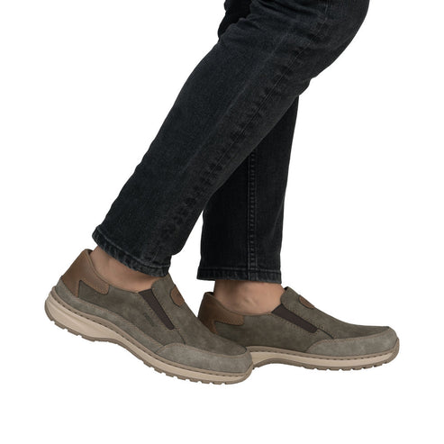 Person wearing gray slip-on shoes.