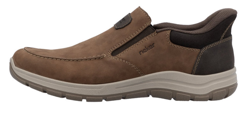Brown slip-on shoe with a light colored sole and the word "rieker" written on the side.