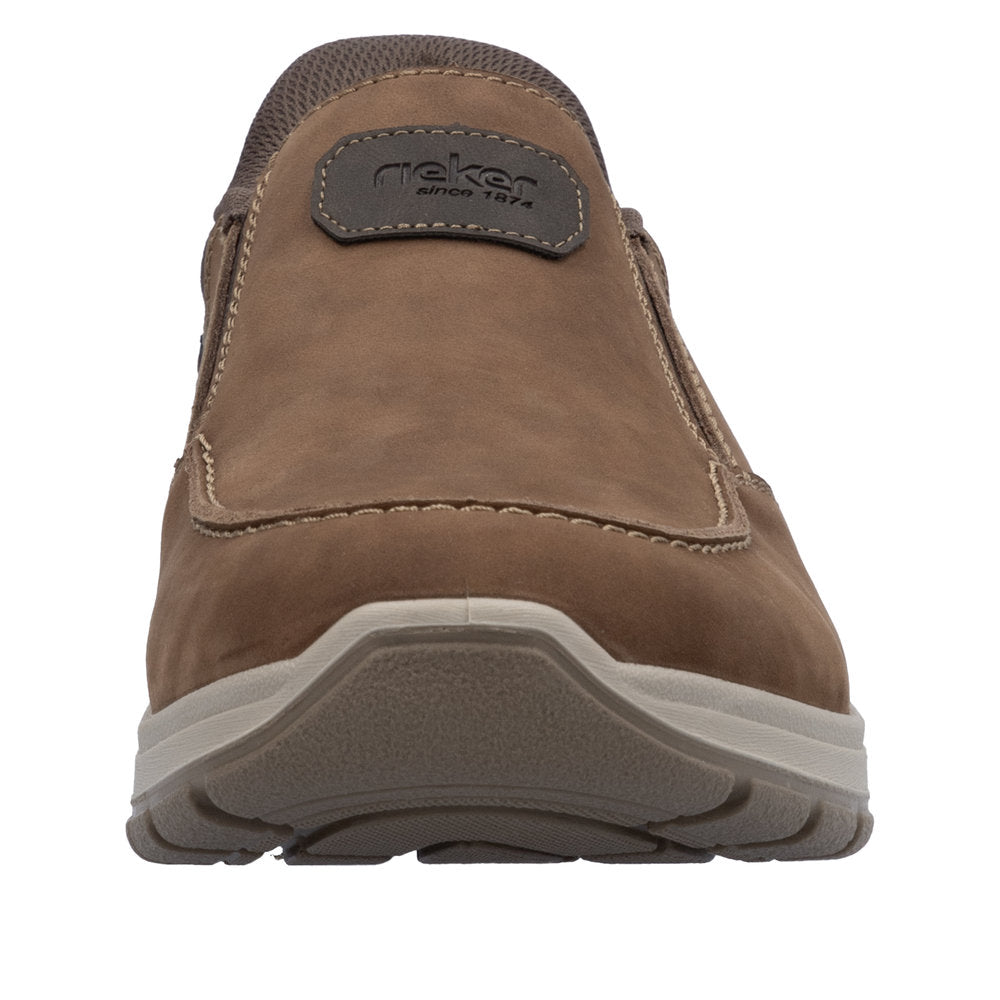 Front view of brown slip-on casual shoe with stitched trim and brand label on tongue.