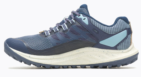 A blue trail running shoe featuring a mesh upper, speckled midsole, and lugged outsole.