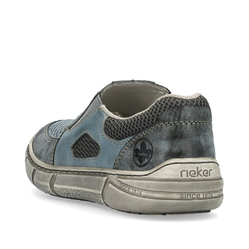 Low-profile faded blue slip-on sneaker with mesh details and chunky, textured sole featuring "rieker" and "since 1874" imprint.