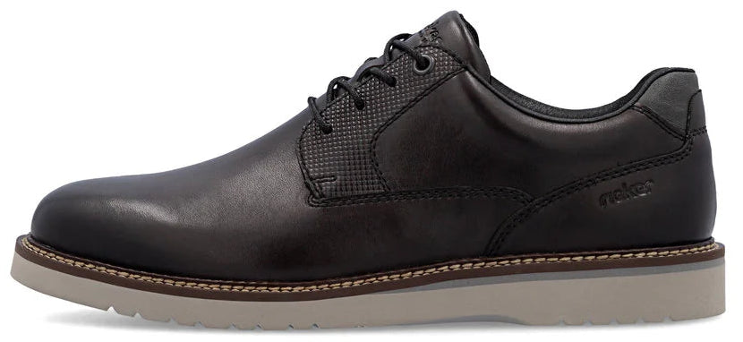 A dark leather dress shoe with a light-colored sole.