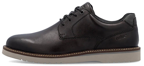A dark leather dress shoe with a light-colored sole.