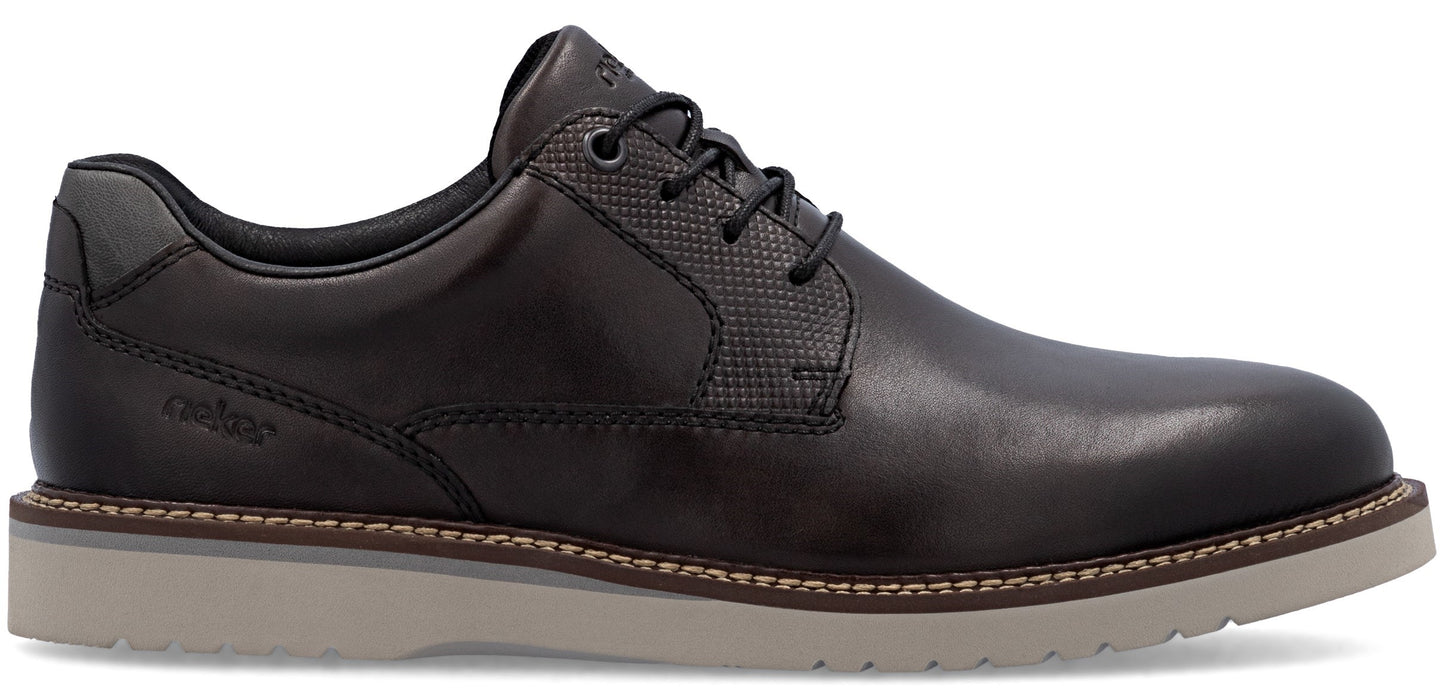 a black leather dress shoe with a lace-up closure and a grey sole