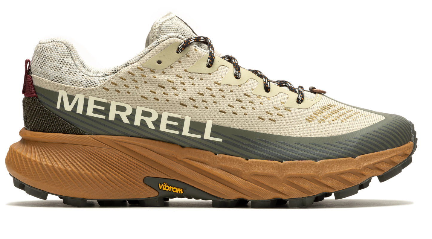 Running shoe with a light beige upper, dark green accents, and brown Vibram sole, prominently displaying the word "MERRELL" in white on its side.