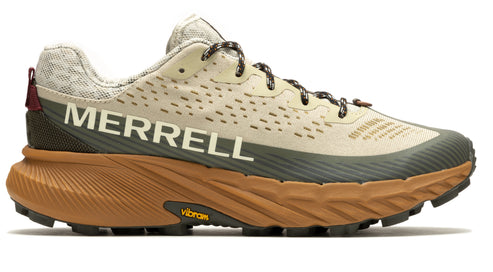 Running shoe with a light beige upper, dark green accents, and brown Vibram sole, prominently displaying the word "MERRELL" in white on its side.