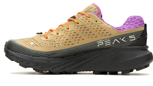 Trail running shoe: tan upper with orange laces, black sole, and a purple heel. "GORE-TEX" and "Agility Peaks" text are on the side.