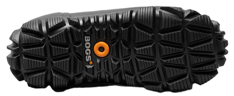 The sole of a dark boot with a deeply lugged tread pattern and a logo with an orange circle in the center.