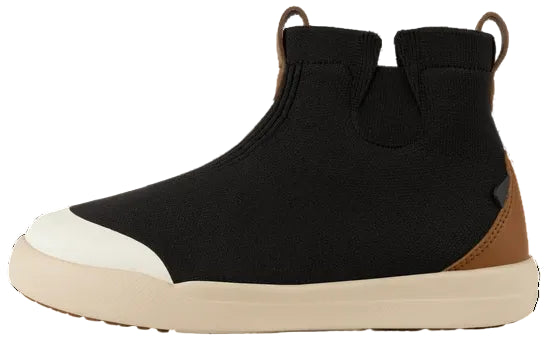 A black ankle-high slip-on shoe with a rounded white toe cap, a tan sole, and a tan heel accent, featuring pull tabs at the back.